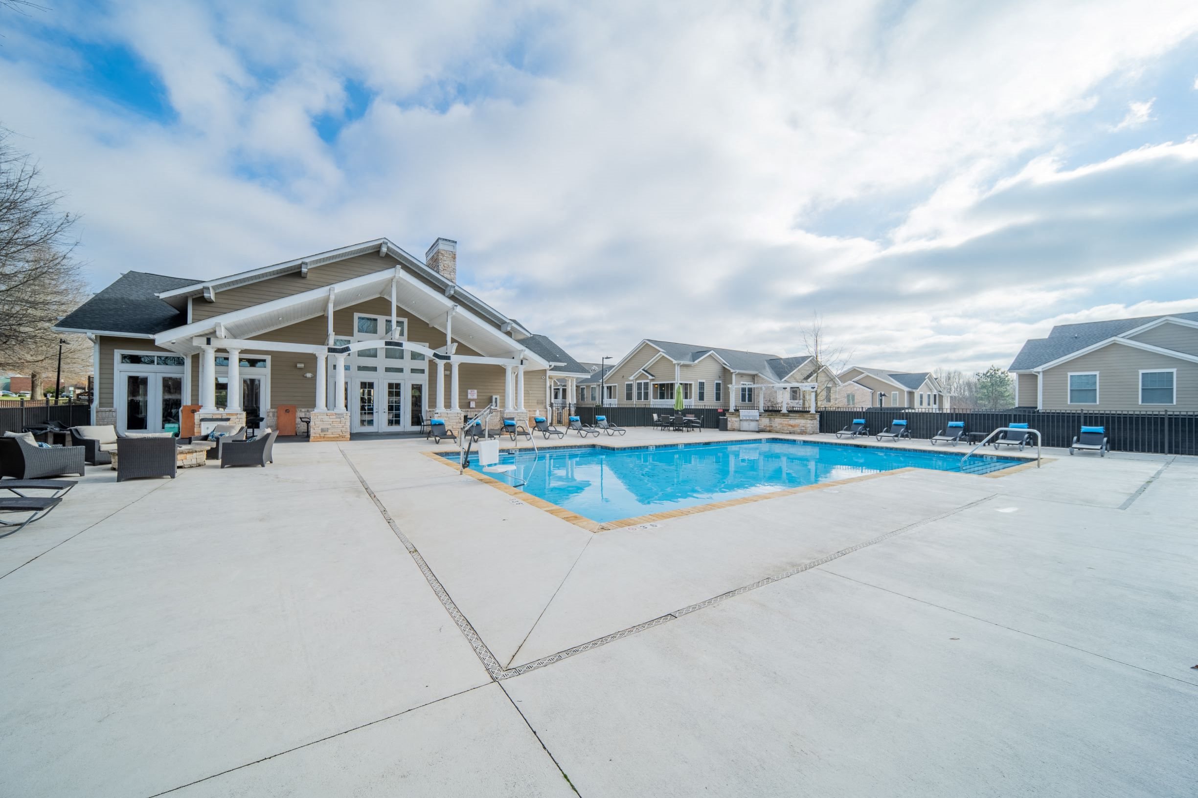 Sparkling swimming pool and spacious sundeck at Piedmont Place apartments in Greensboro, NC